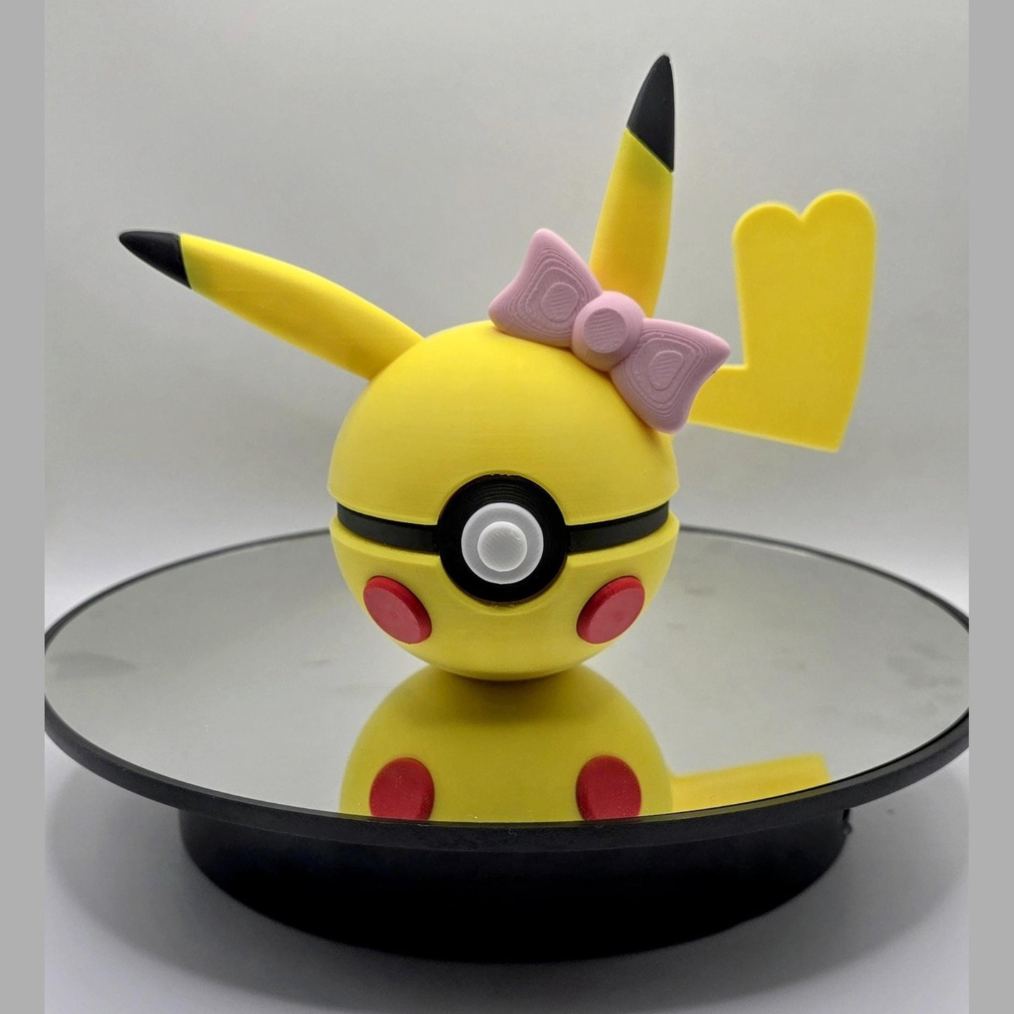 3D printed yellow electric mouse creature ball with pink bow and blushing cheeks
