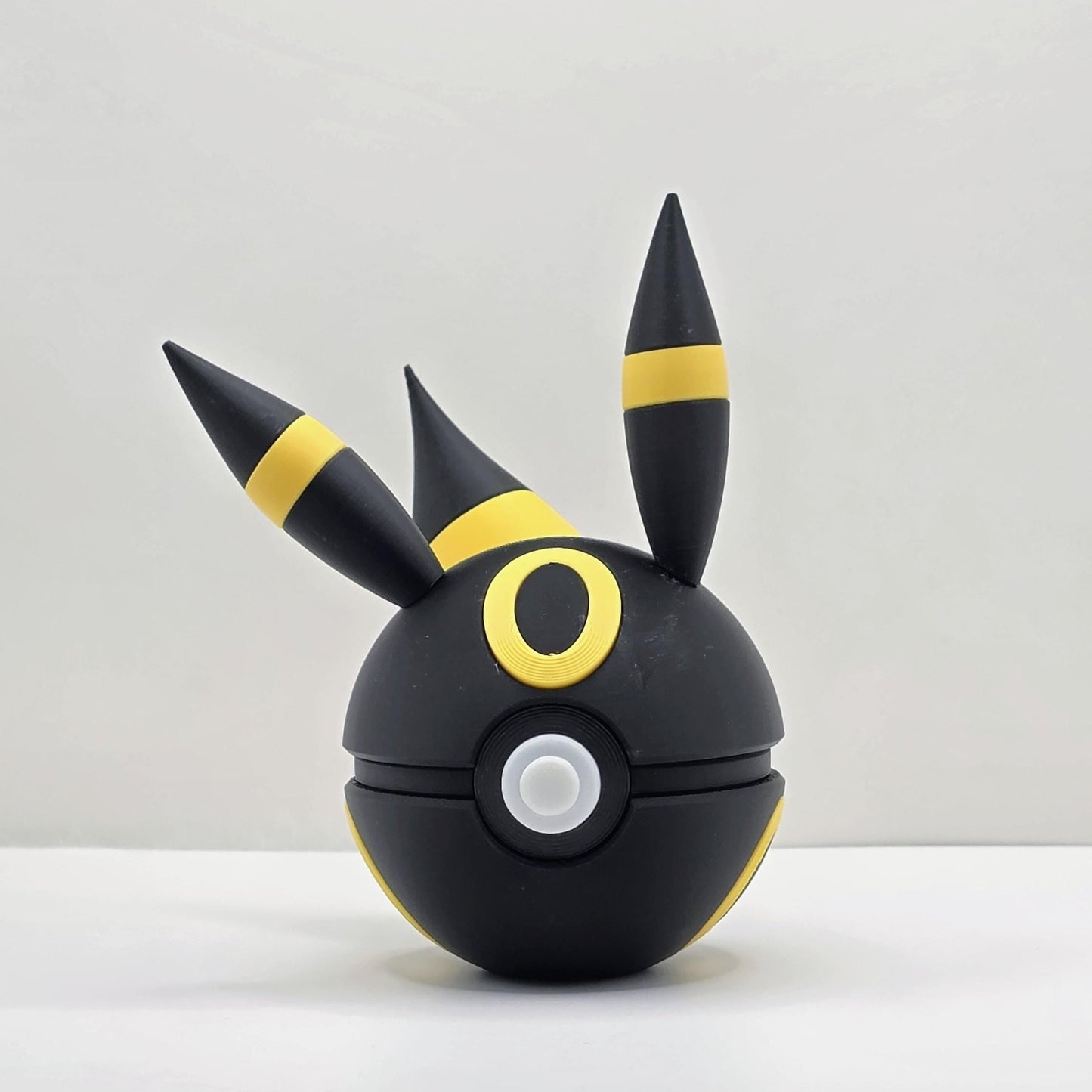 3D printed black and gold dark eclipse moon fox creature ball with sculpted rings