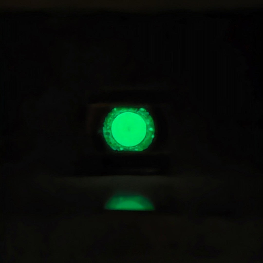 Close up of the power ring showing glow in the dark center stone lit up in dark
