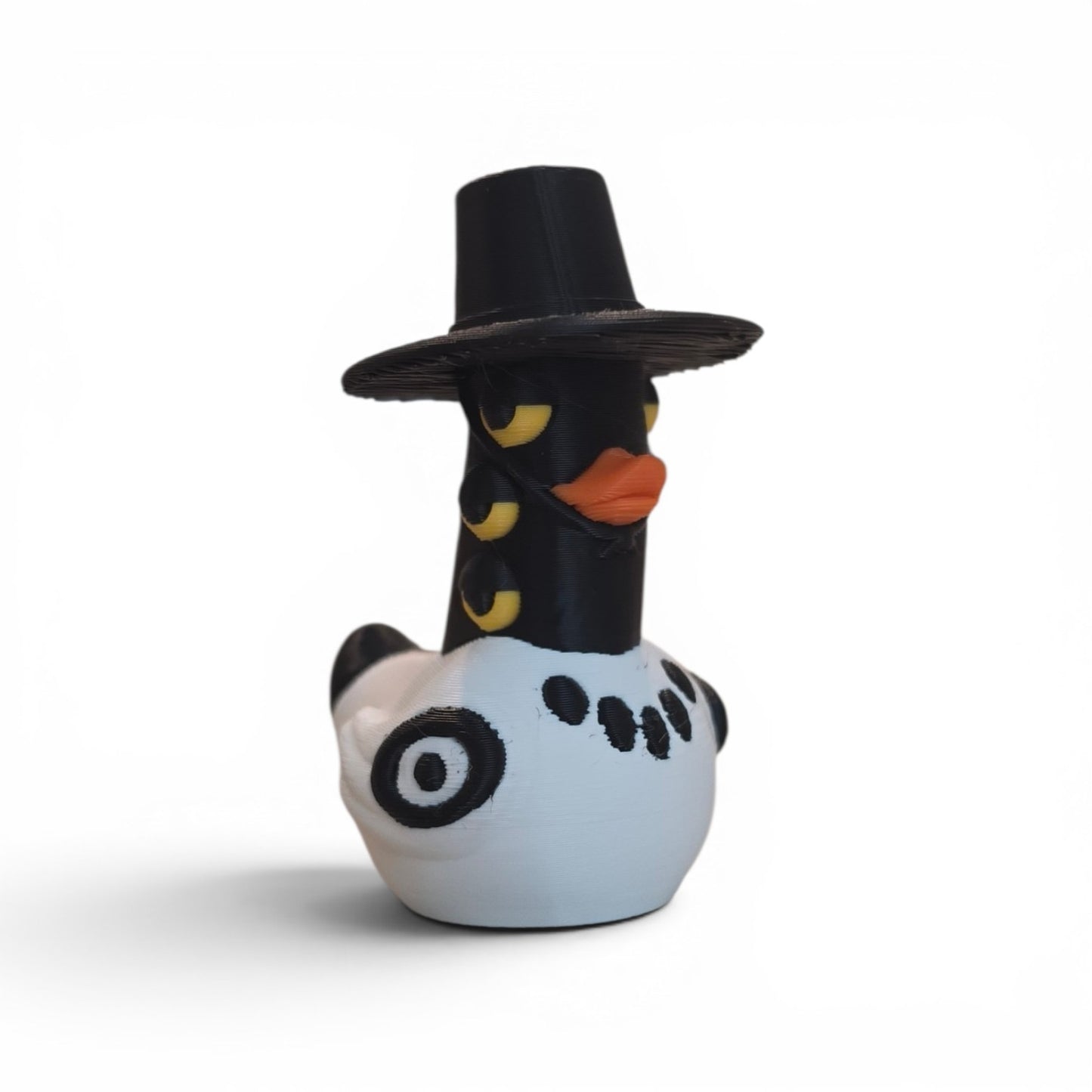 Close up of the Sussie duck showing black wide brimmed hat and yellow multi-eye detail