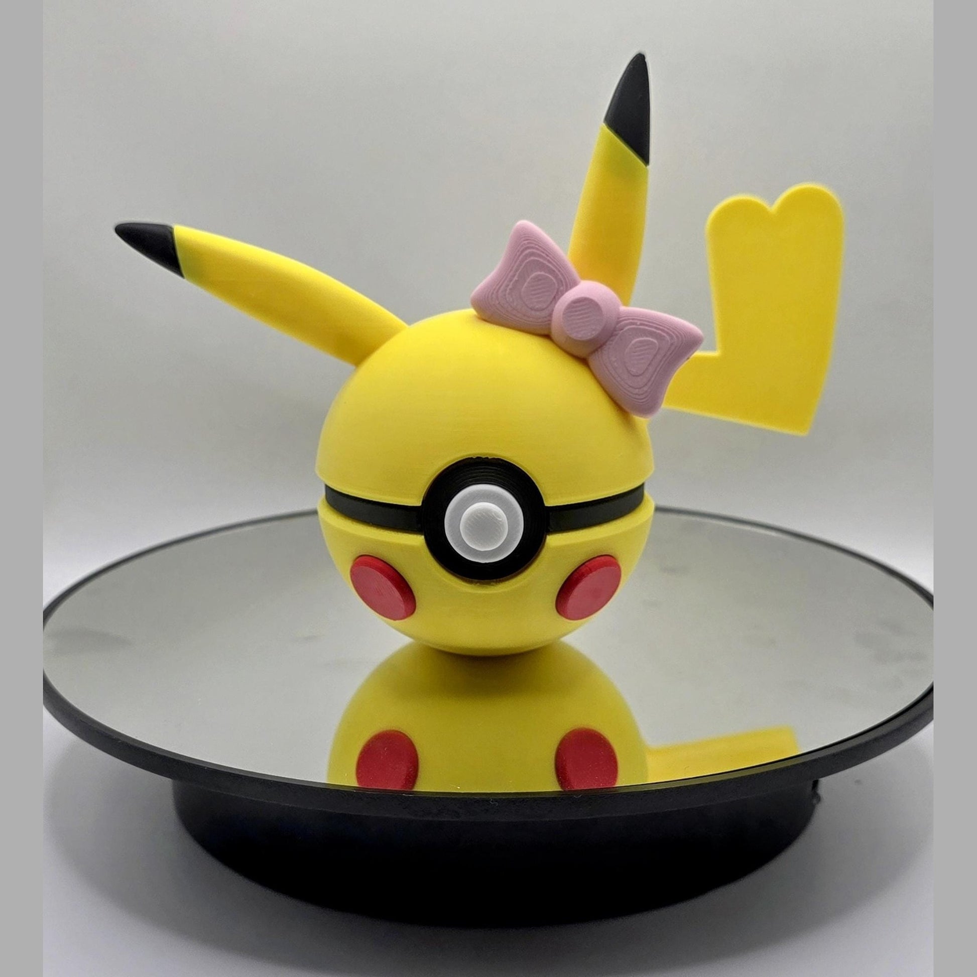 3D printed yellow electric mouse creature ball with pink bow and blushing cheeks