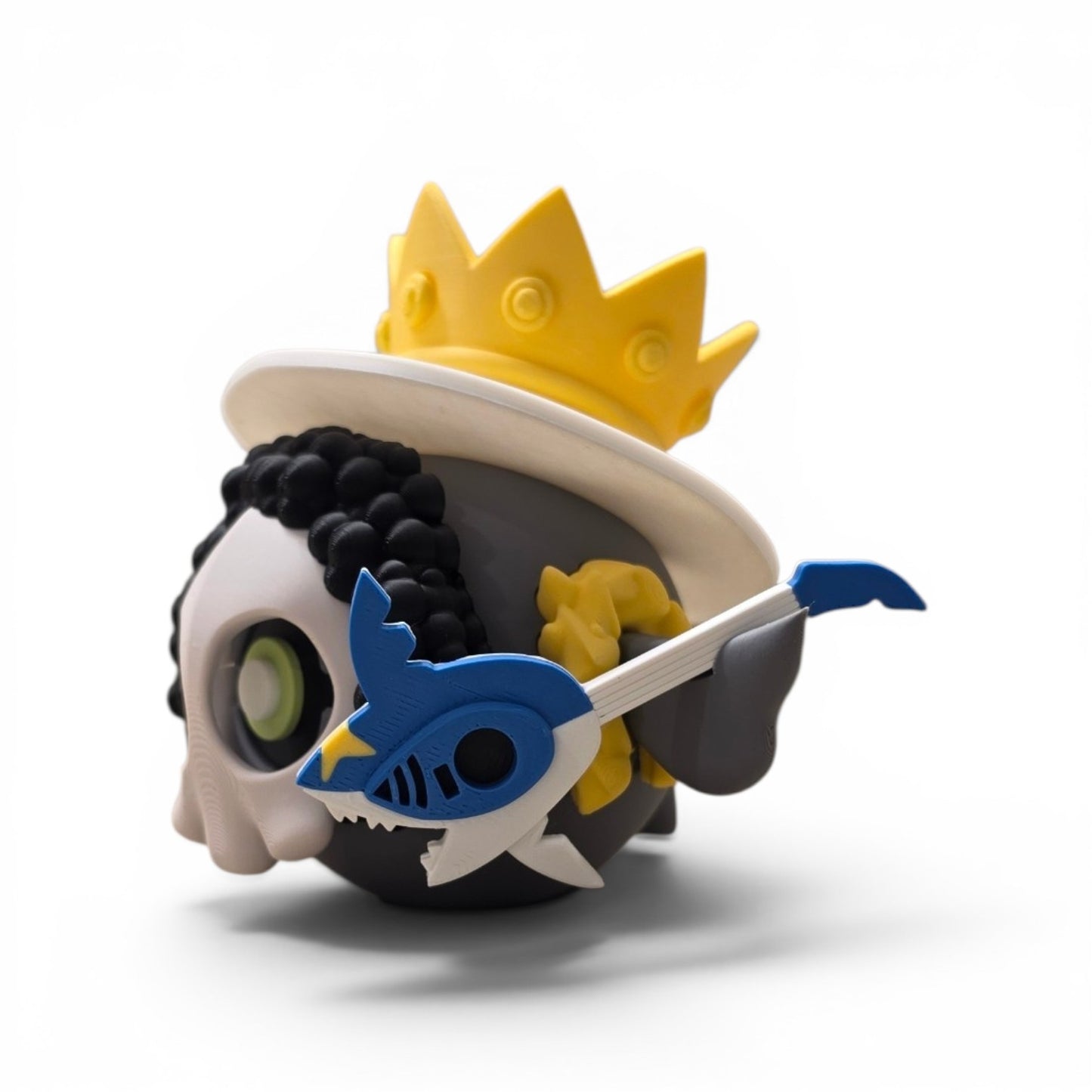Close up of the mashup creature ball showing gold crown top hat and skull face detail