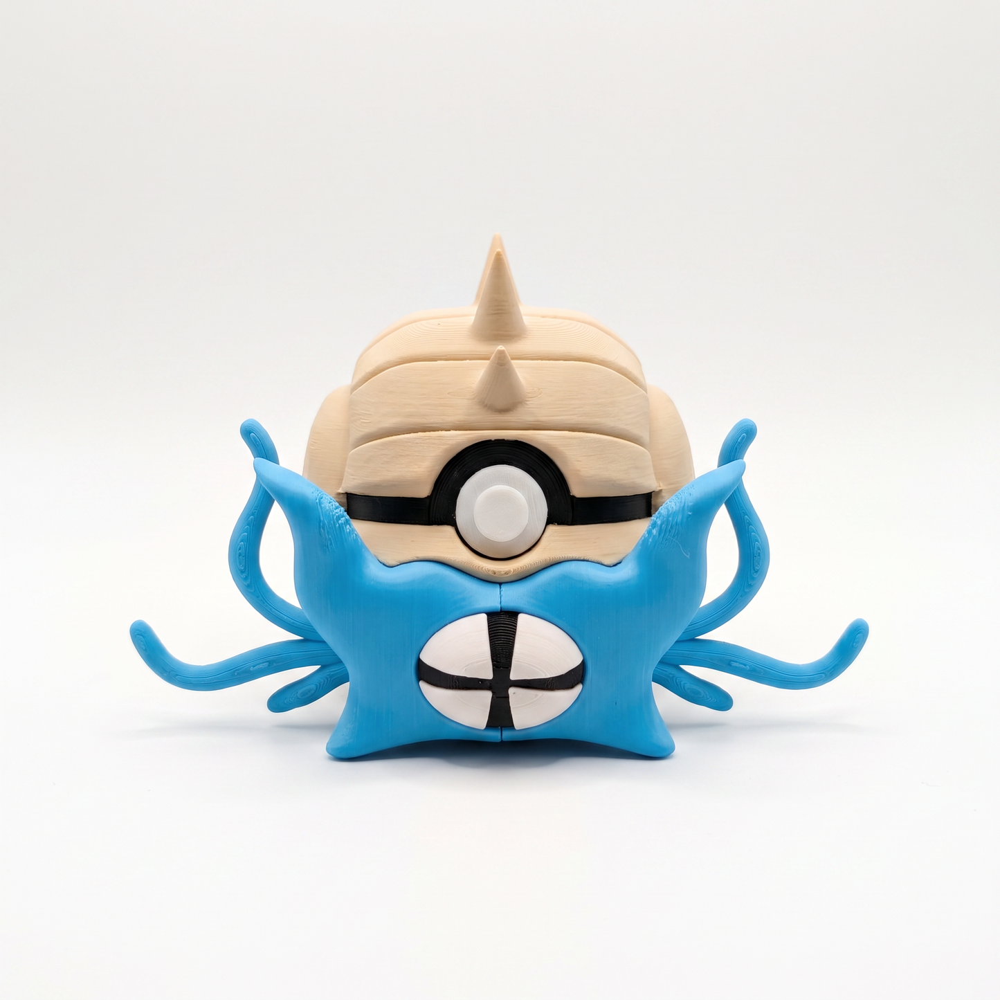 Close up of the spiky shell creature ball showing serrated shell crown and slit pupil eye detail