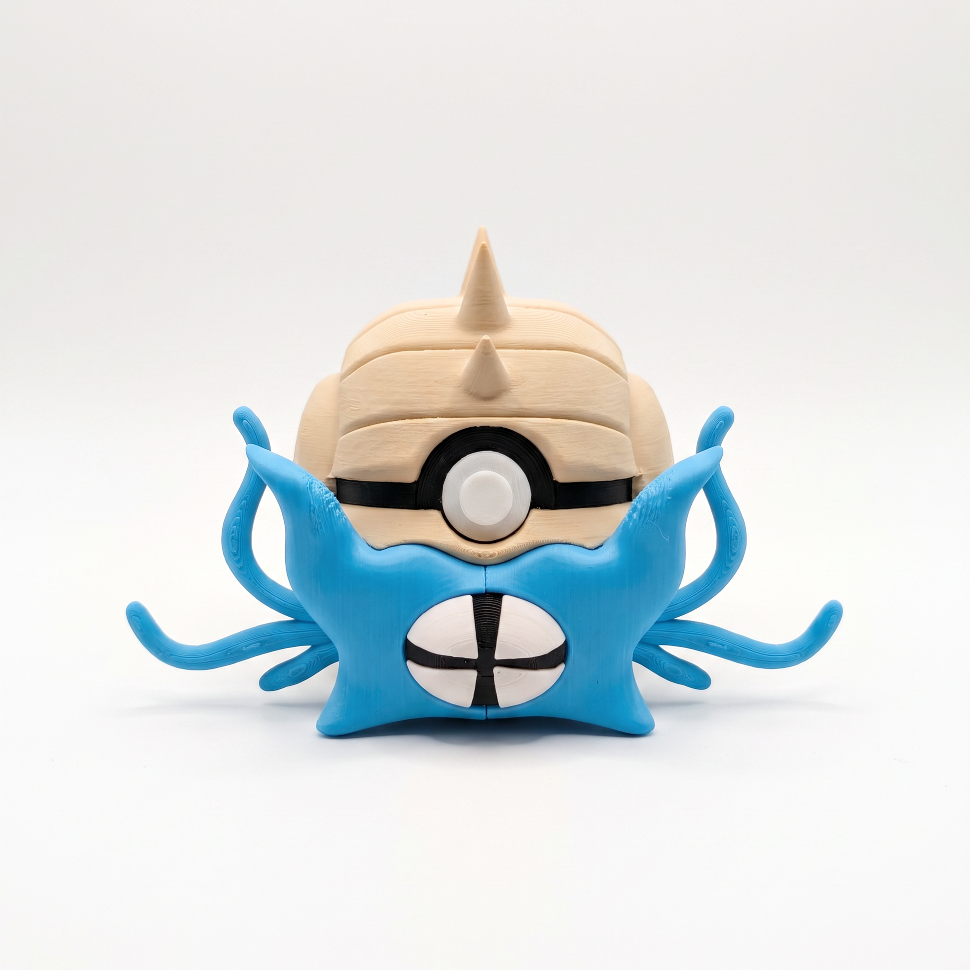 Close up of the spiky shell creature ball showing serrated shell crown and slit pupil eye detail