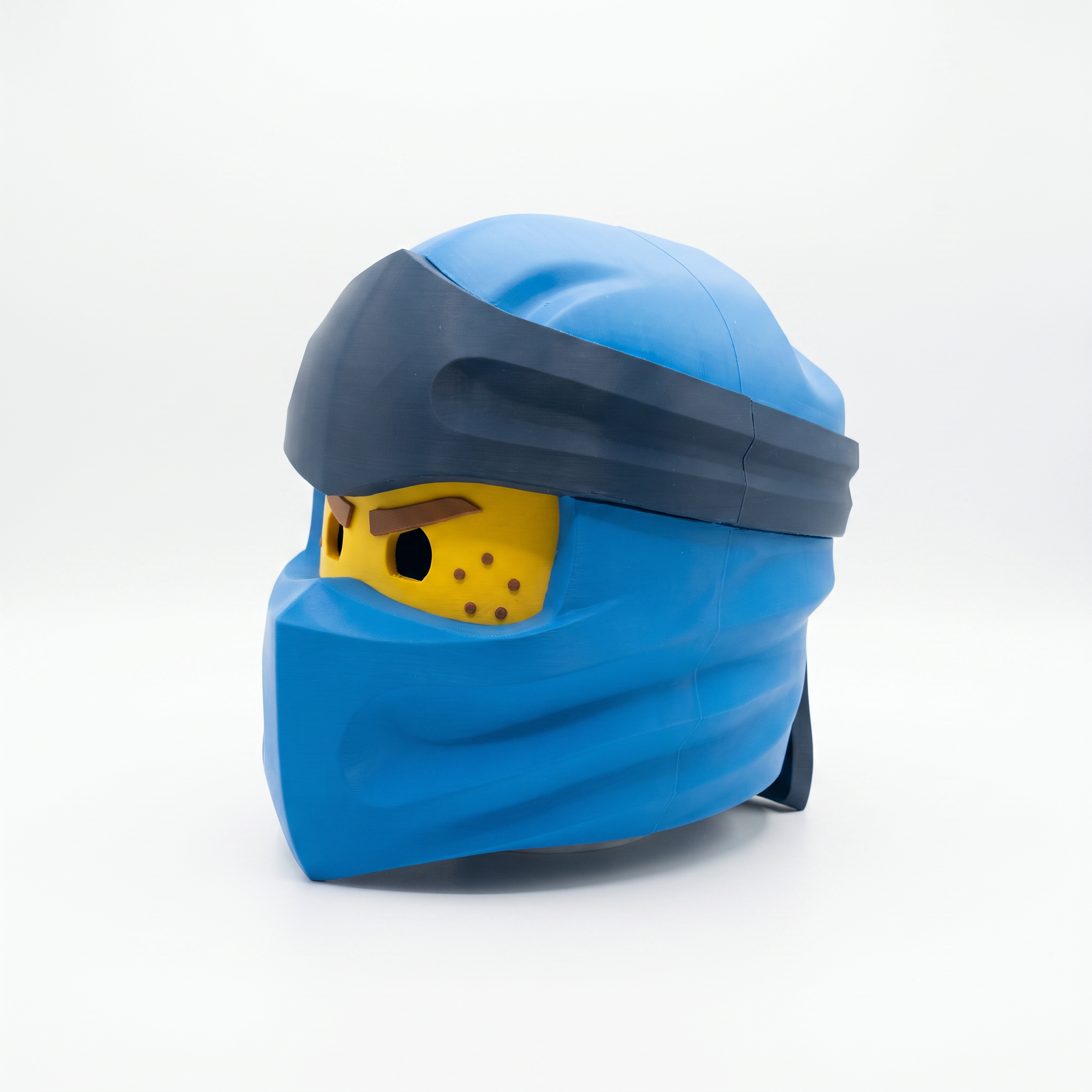 Close up of the ninja helmet showing yellow face panel with sculpted brown eyebrow detail
