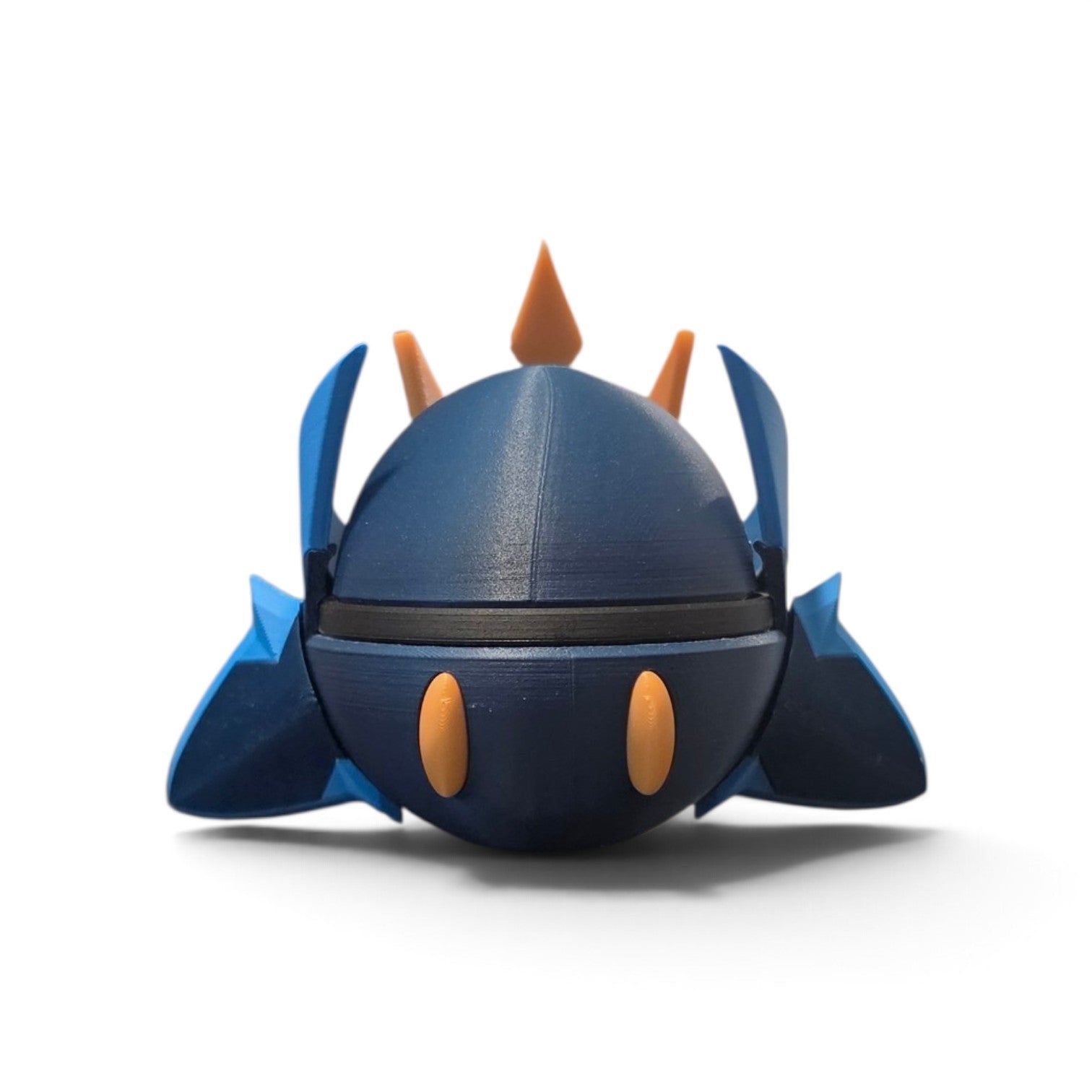 Close up of the creature ball showing blade-tipped flippers with gold orange claw accents spread wide