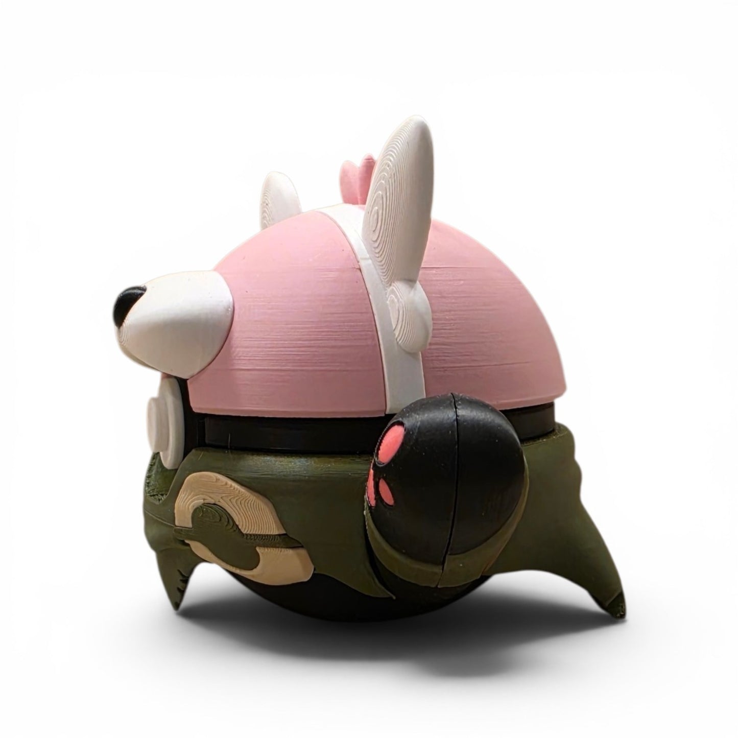 Close up of the creature ball showing pink upper head with white ear tufts and muzzle detail