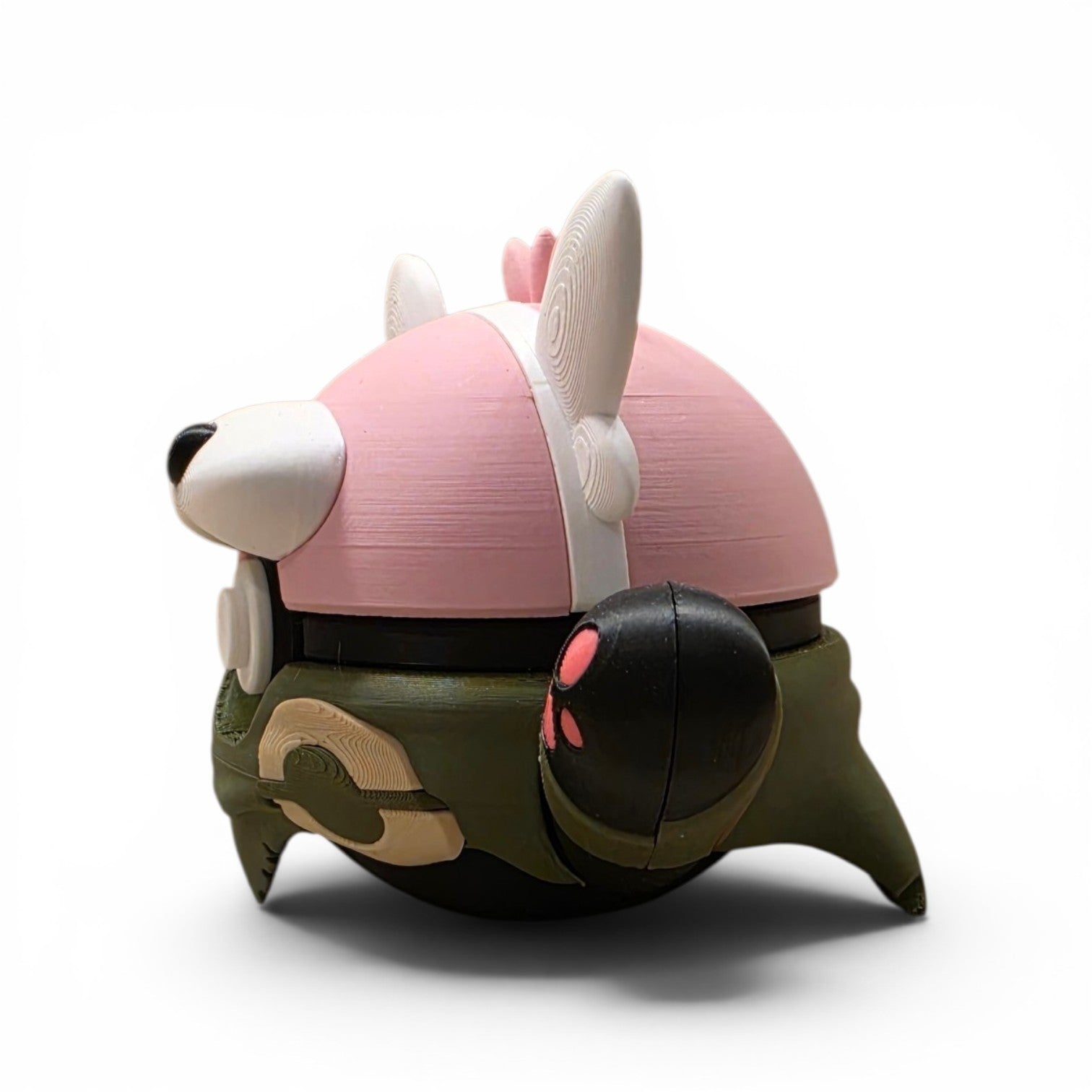Close up of the creature ball showing pink upper head with white ear tufts and muzzle detail