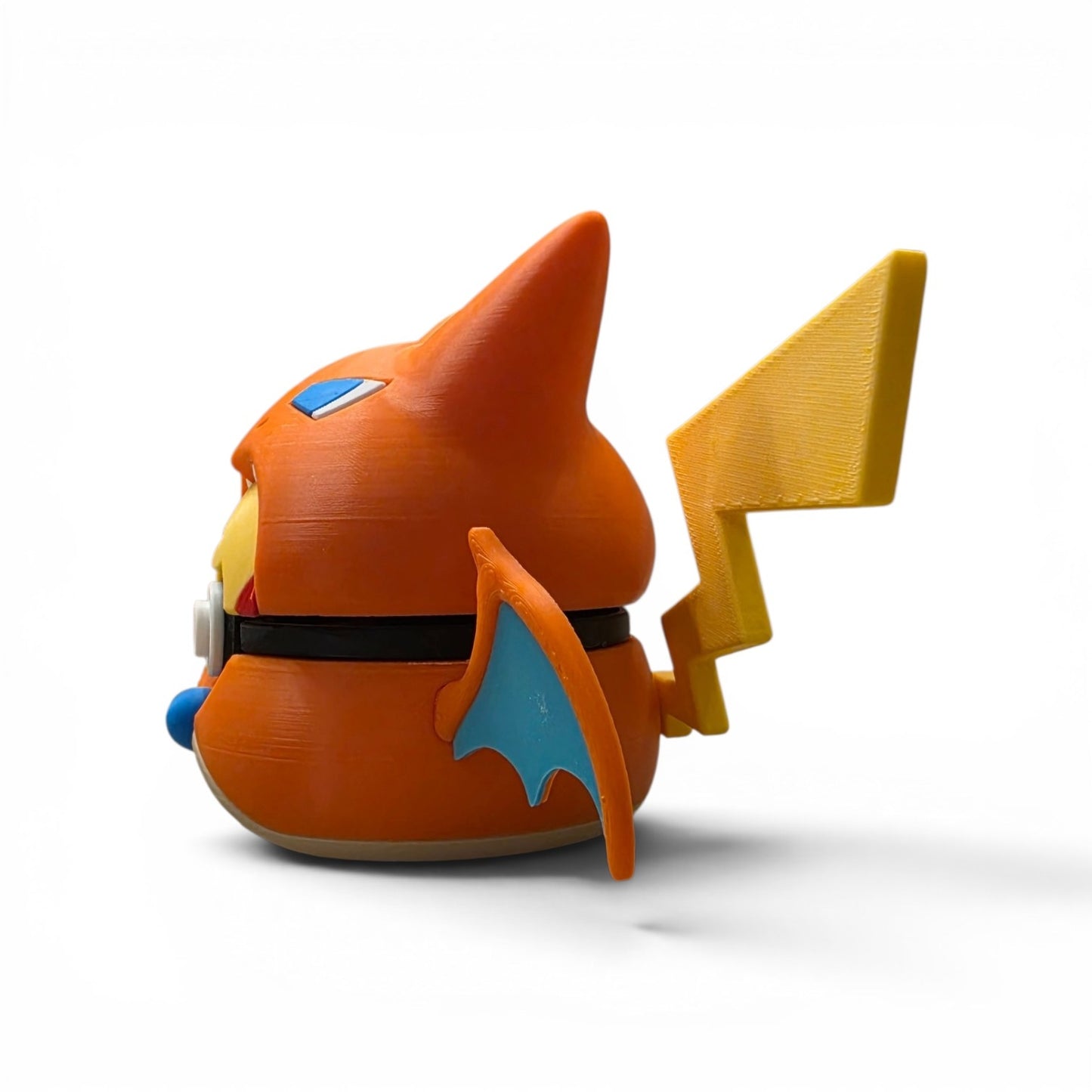 Close up of the creature ball showing teal bat wings and orange fire dragon hood detail